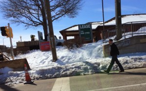 A pedestrian avoids the snow by walking near traffic at Sunset Hills and Wiehle Avenue/Credit: Bruce Wright