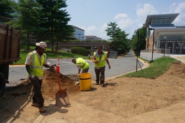 Putting final landscaping touches on South entrance to Wiehle-Reston East